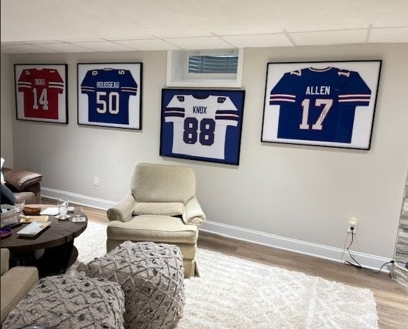 Four framed Buffalo Bills jerseys — Diggs 14, Rousseau 50, Knox 88, Allen 17 — displayed on a basement wall