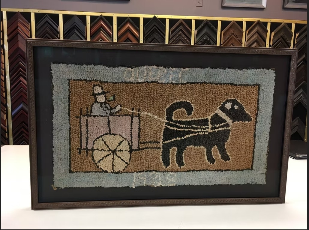 Framed antique hooked rug depicting a cart and horse
