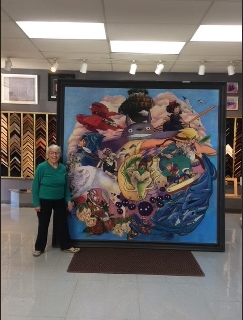 Large framed anime artwork display with customer