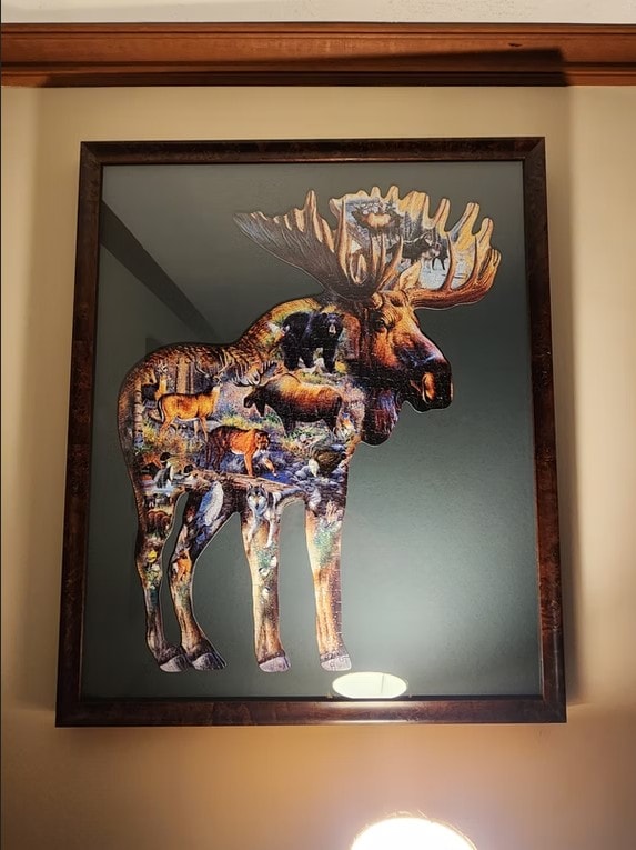 Framed moose-shaped wildlife puzzle artwork displayed on a wall