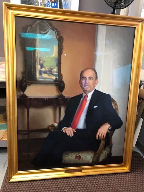 Framed formal portrait of a businessman in a red tie