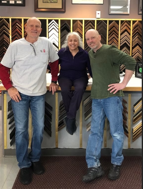 Three Frame Shop of Henrietta team members smiling in the store